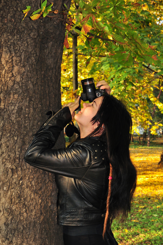 image of a lady taking pictures on her camera 